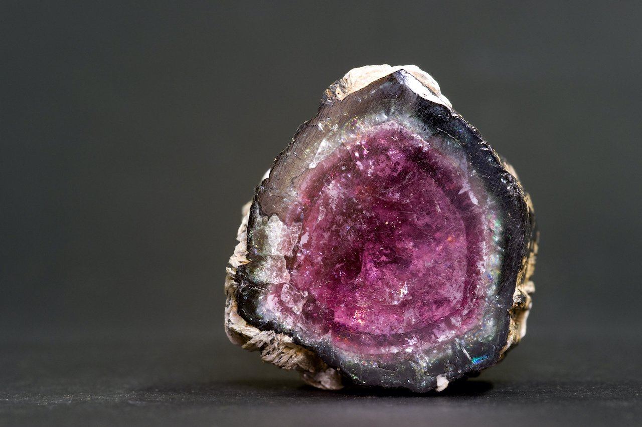 Slice of watermelon tourmaline with a pink center and a dark rim