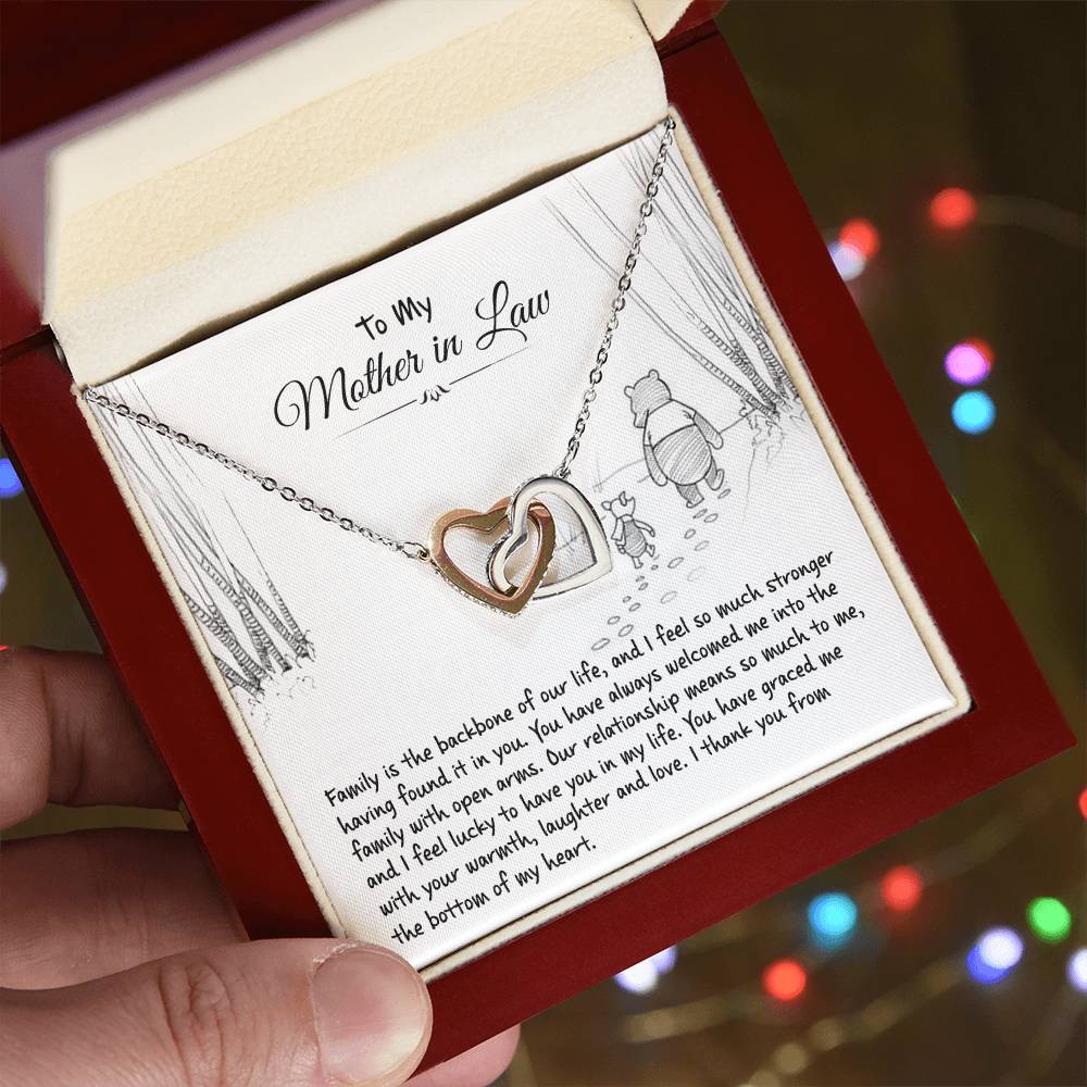 Hand holding the gift box with Interlocking Hearts Necklace and To My Mother in Law card
