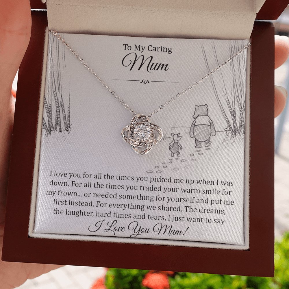 Hand holding the open gift box with Love Knot Necklace and To My Caring Mum card