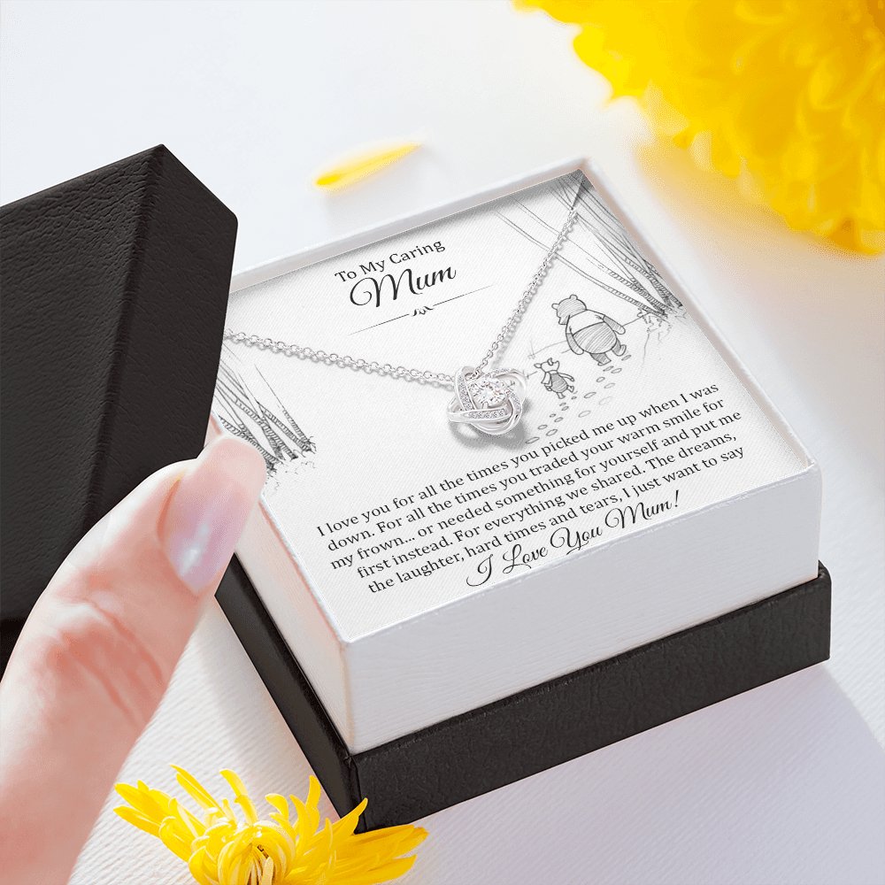 Hand holding the gift box with Love Knot Necklace and To My Caring Mum message card