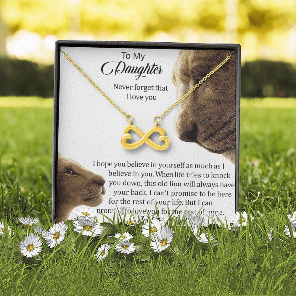 Infinity Necklace in yellow gold with To My Daughter card displayed on grass with daisies