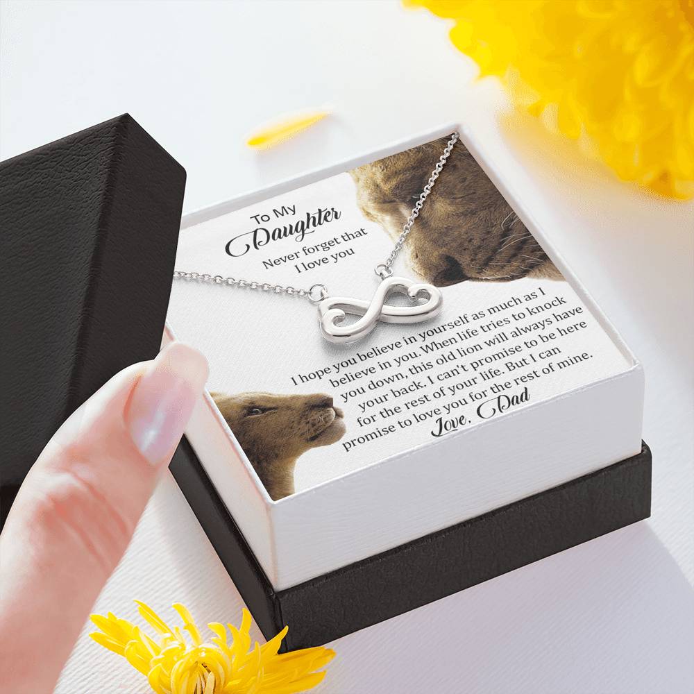 Hand holding the gift box with Infinity Necklace and To My Daughter message card