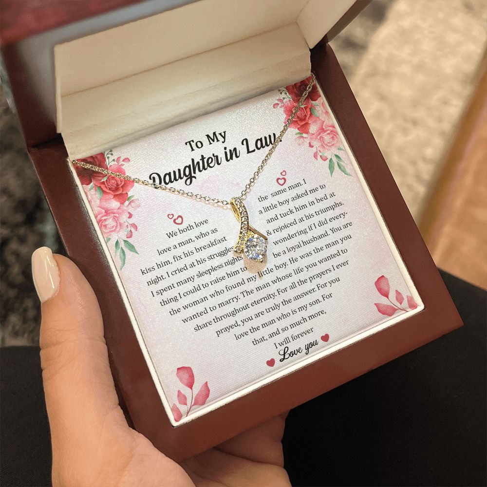 Hand holding the open gift box with Sparkling Radiance Necklace and To My Daughter In Law card