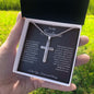 Hand holding the gift box with Personalized Cross Necklace and To My Soulmate card outdoors