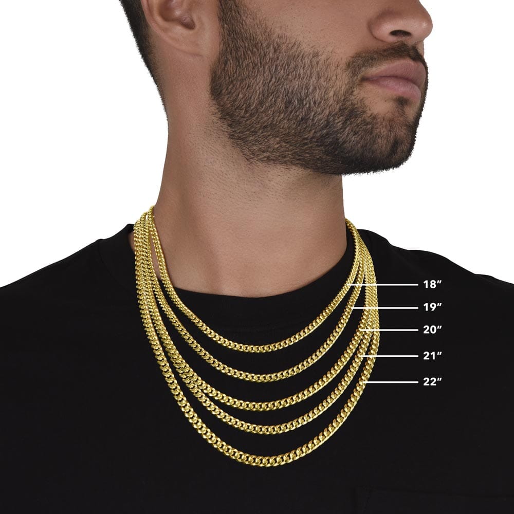 Model wearing the Cuban Link Chain Necklace with size guide, yellow gold finish