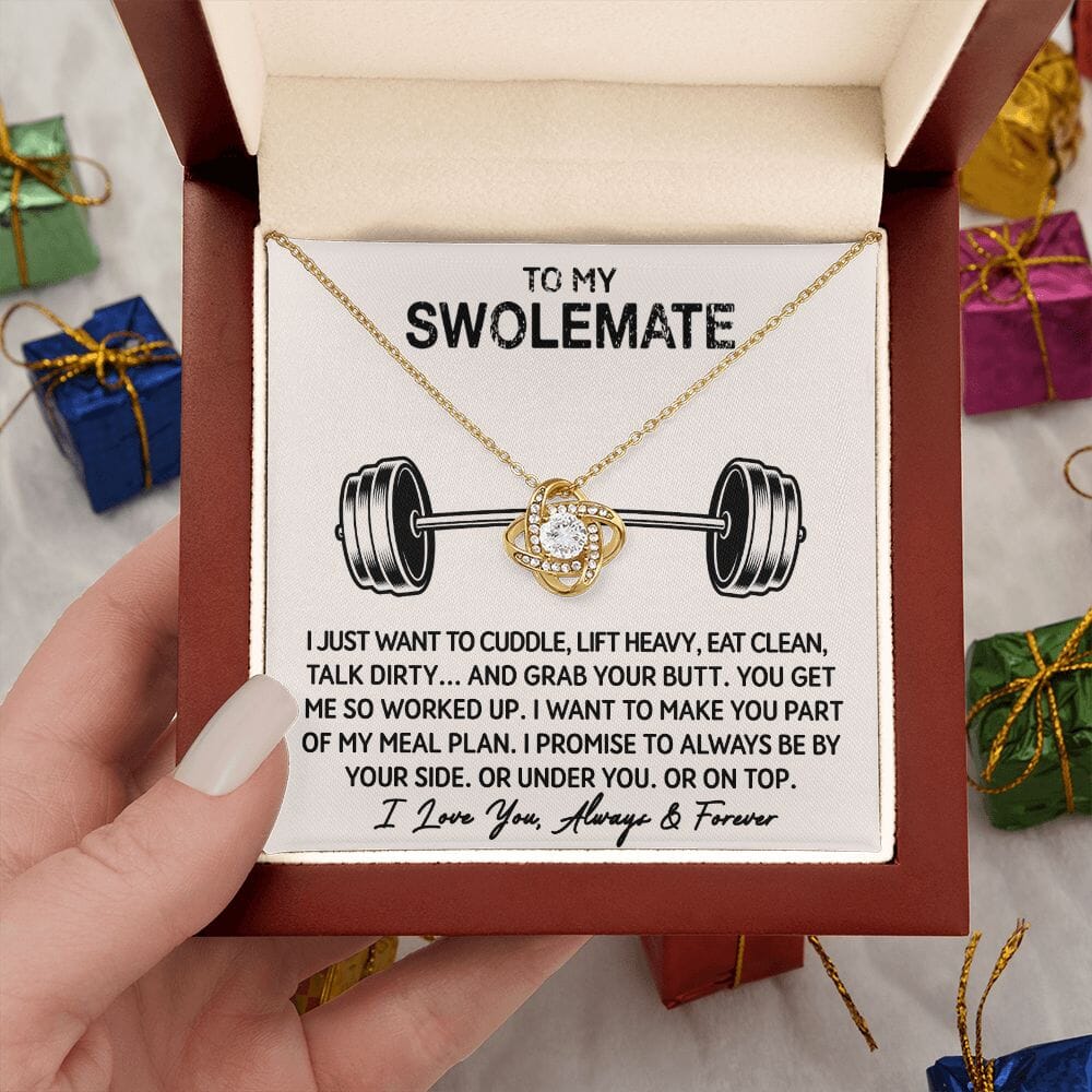 Hand holding the open gift box with Love Knot Necklace and To My Swolemate card, yellow gold finish