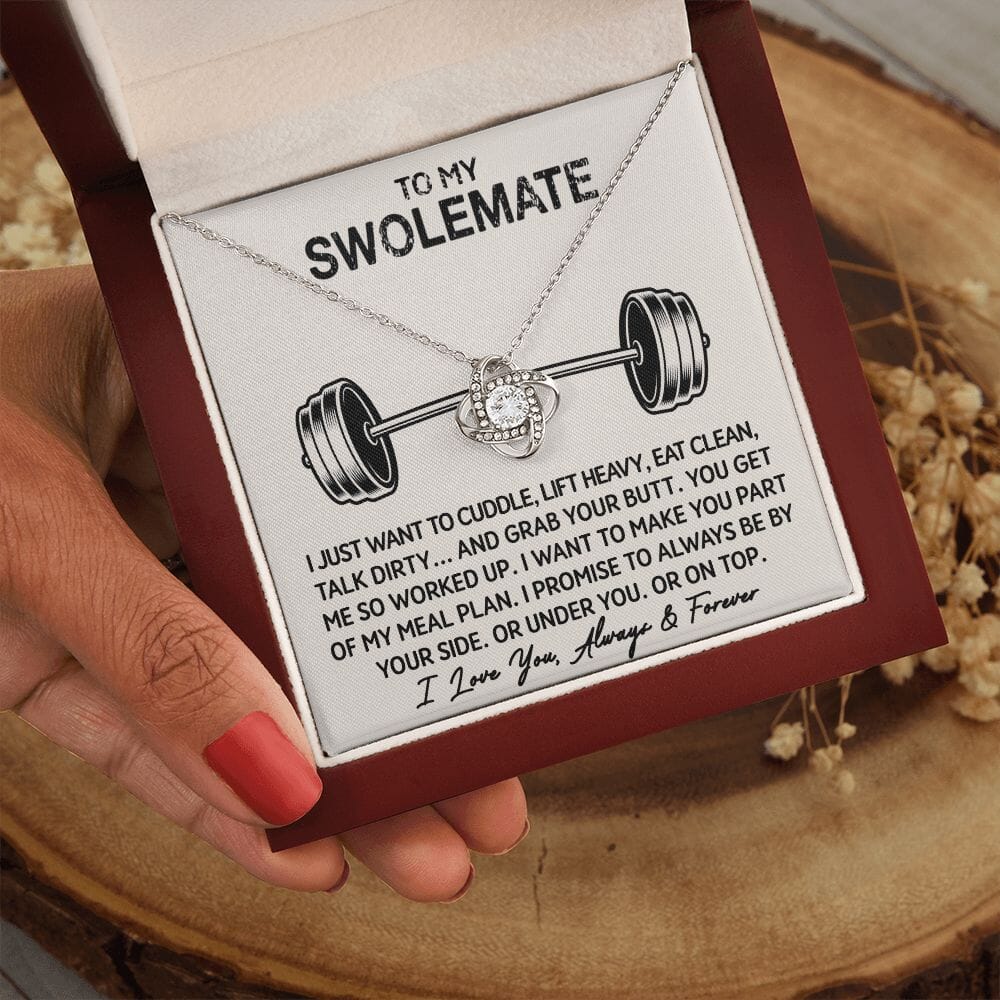 Hand holding the open gift box with Love Knot Necklace and To My Swolemate card